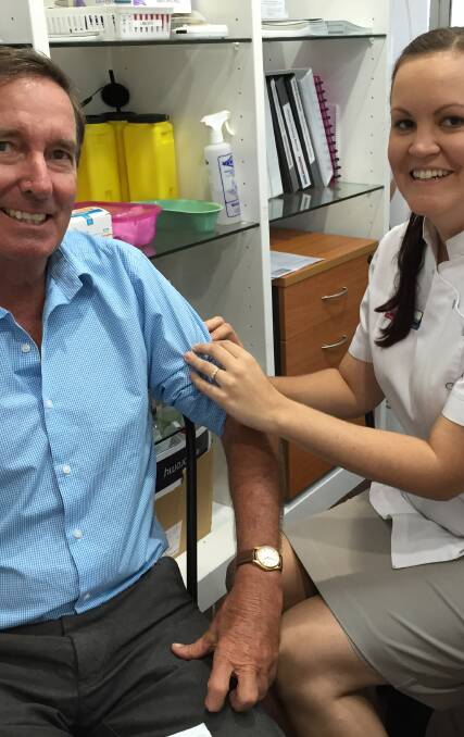 North West Hospital and Health Board Chair, Paul Woodhouse receives his flu vaccination from Mount Isa’s Pharmacy First pharmacist Shana O’Connor.