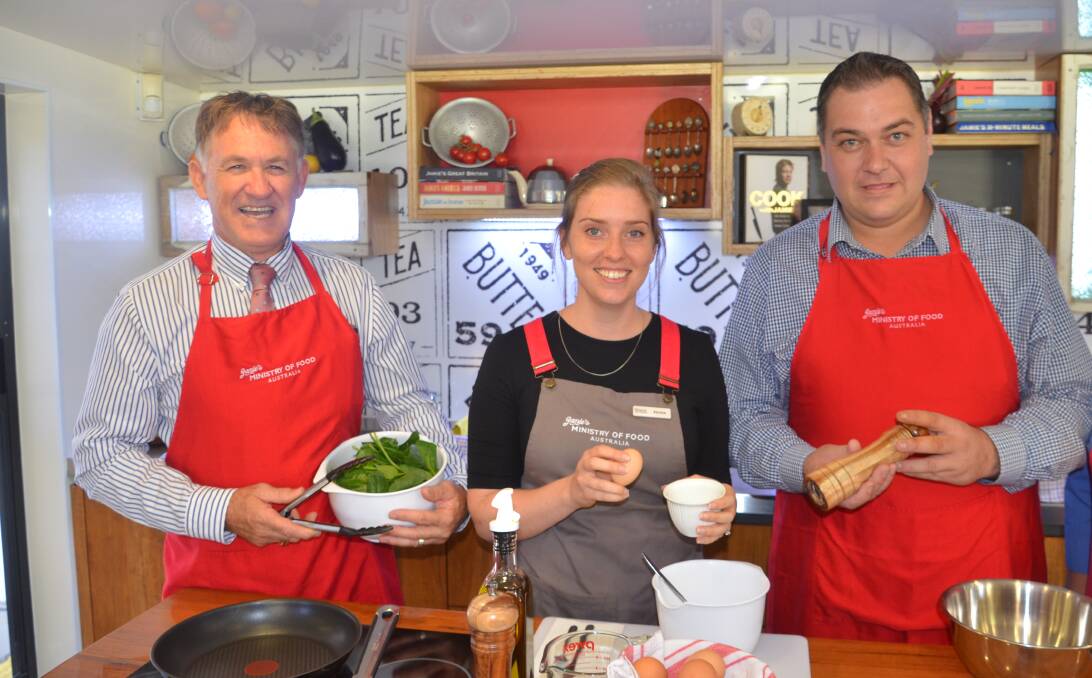 Deputy Mayor Phil Barwick, Jamie Ministry of Food's Renee Truscott and Woolworth's John Neal get cooking in Mount Isa.