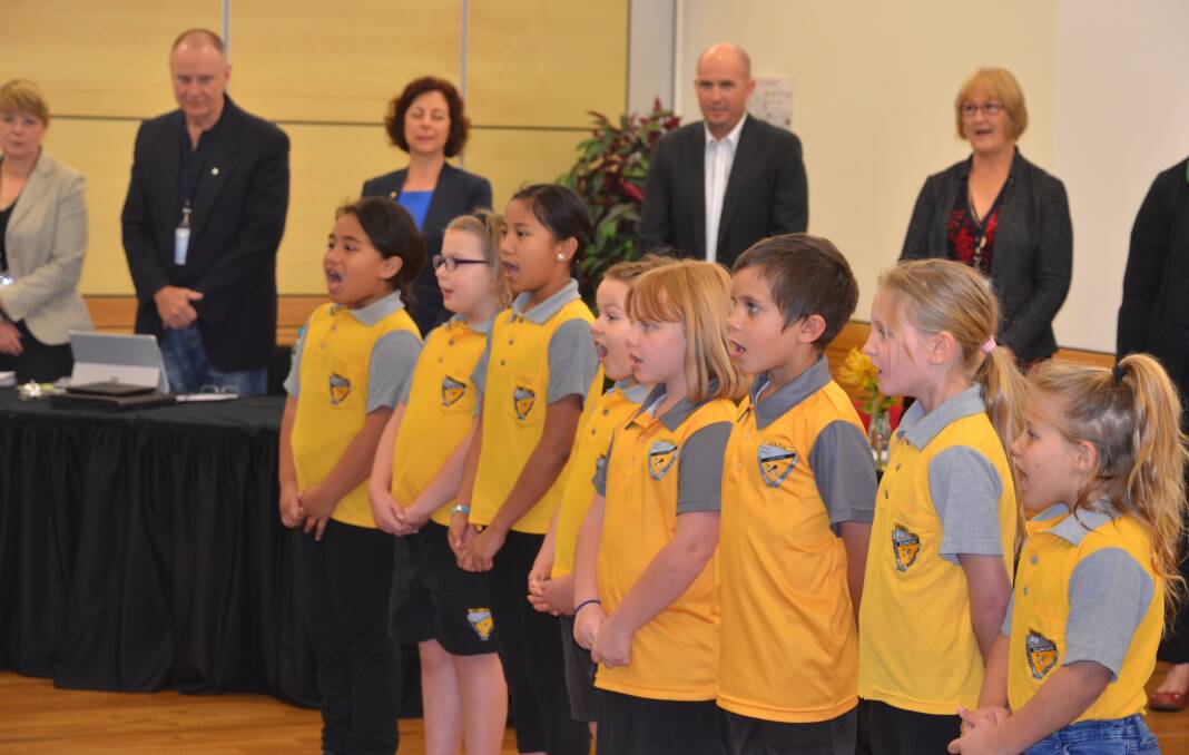 Cloncurry State School students sing the national anthem.