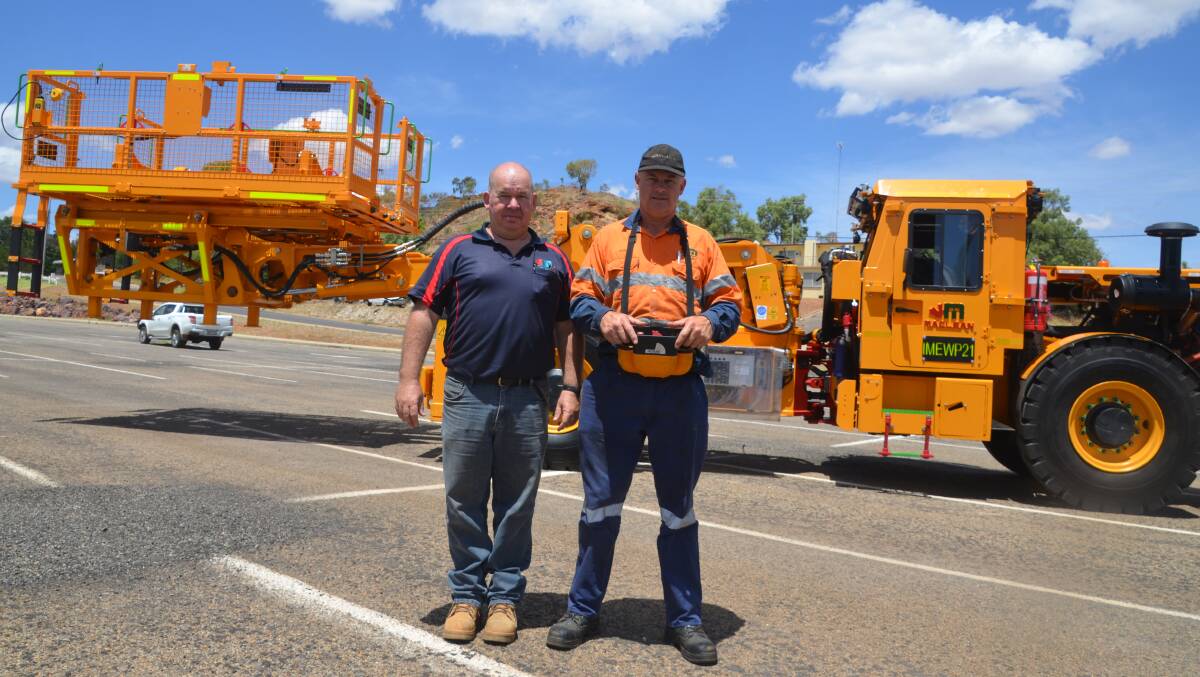HEAVY LIFT: Steve Thomas and Dave Kuerschner with the LR3 unit in Mount Isa. Photo: Derek Barry