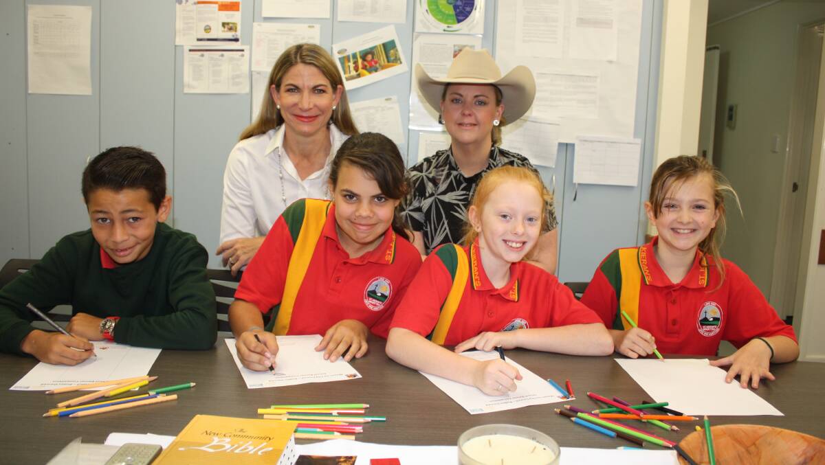 St Kieran’s Catholic Primary School students Gabriel Wood, 11, Darcy Webber, 11, 
Kamryn Langford, 10, and Aiva Tyrie, 10, are busy with their competition entries, encouraged by Mayor Joyce McCulloch and Mount Isa Mines Rotary Rodeo Manager Natalie Flecker.