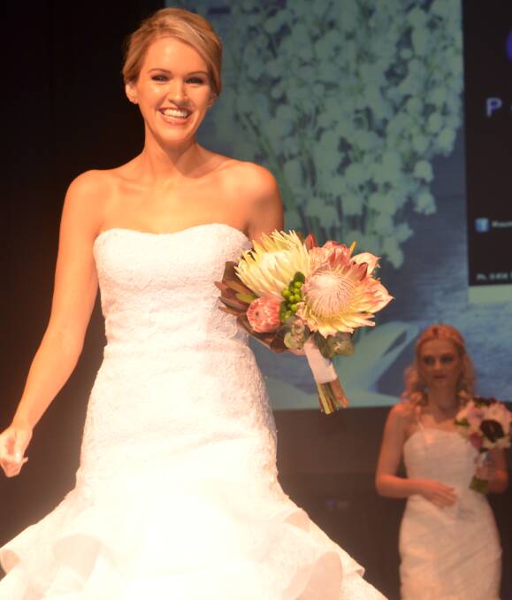 WEDDING BELLS: Models try out wedding dresses at the Expo. Photo: Derek Barry