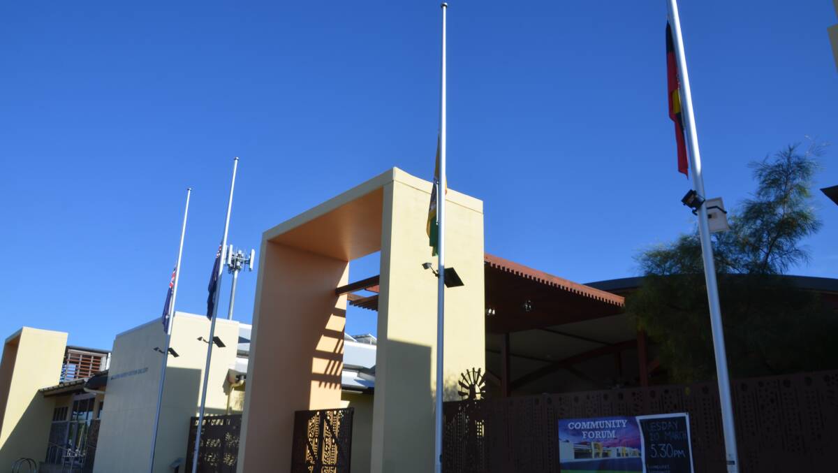 Flags at half mast in Cloncurry to commemorate Bob McDonald outside the library named in his honour.