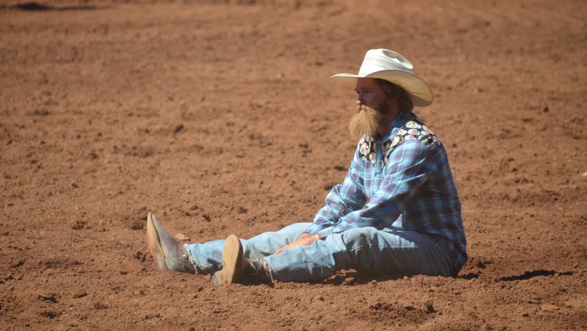 Last year's winner Lachie O'Neill hits the deck after his ride in the steer wrestling.