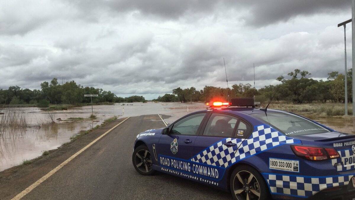 NO WAY: Police block the Flinders Hwy at Canal Creek east of Cloncurry. The wet weather is heading back north into that region. Photo: QPS