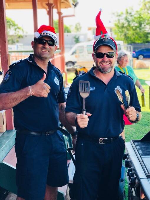 Police Sergeant Amit Singh and Senior Constable Jason Jesse cook up a storm at the Camooweal Christmas festivities.