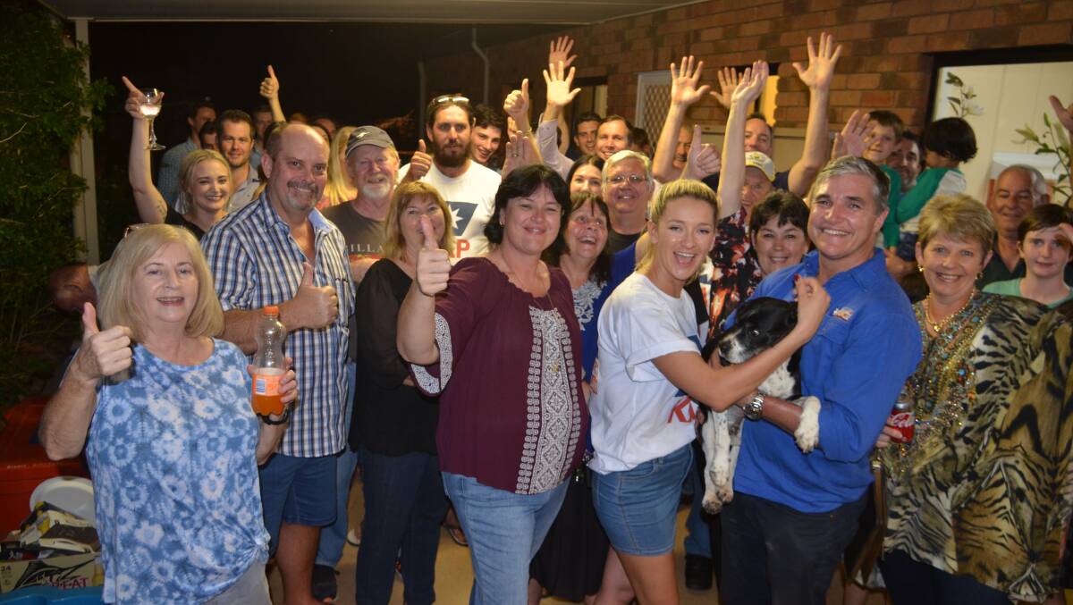 WINNERS: Robbie Katter, wife Daisy and dog Jon Bon, celebrate victory with supporters in Mount Isa. Photo: Derek Barry