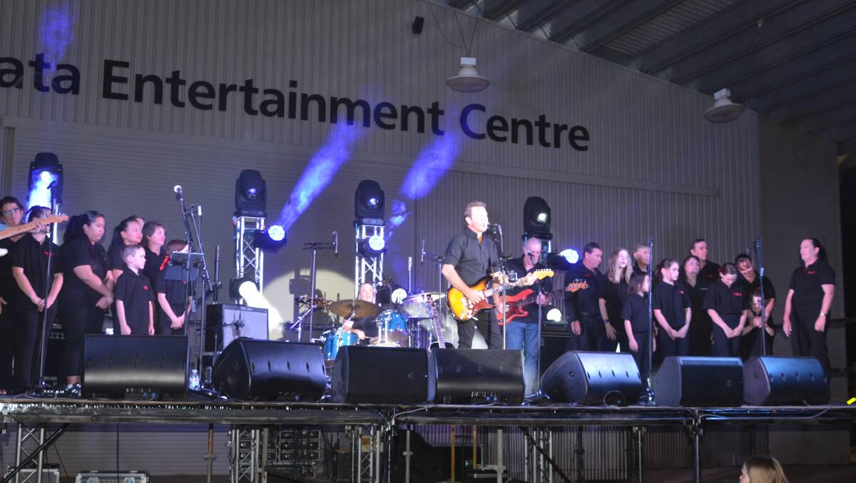 TOP NIGHT: Troy Cassar-Daley is supported on stage by the local MICE choir. Photo: Derek Barry