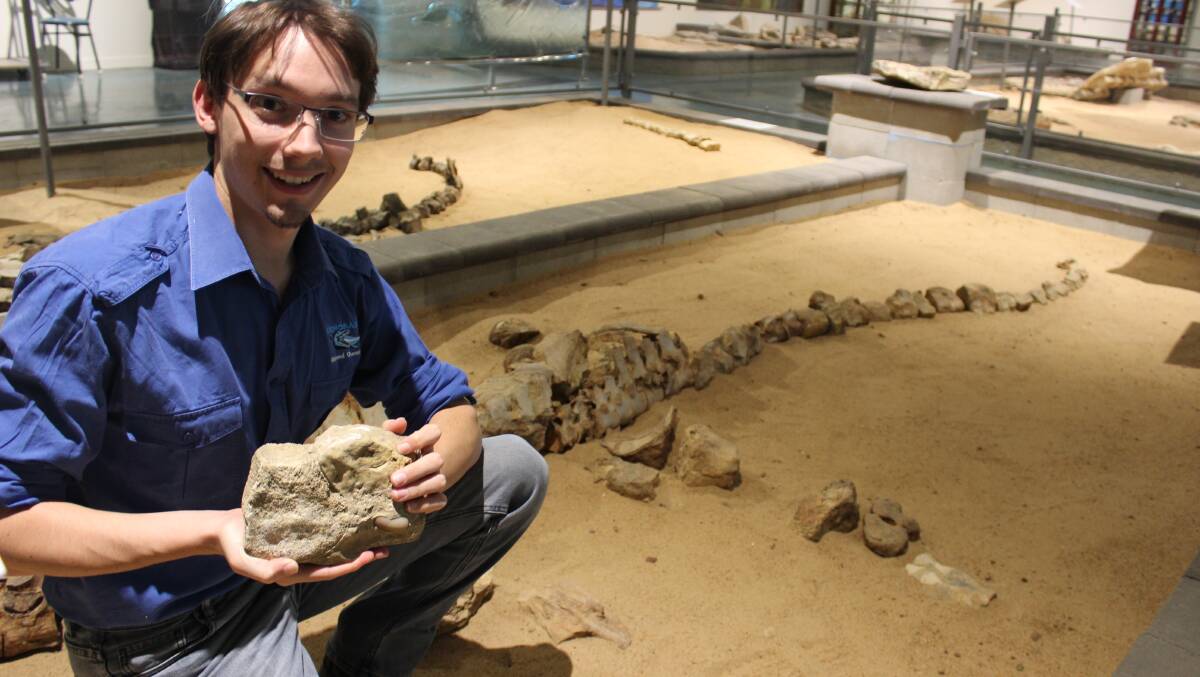 FIND: Dr Patrick Smith shows a fossil of a rare dino-bird in front of an Elasmosaurus skeleton at Richmond's Kronosaurus Korner. Photo: Samantha Walton