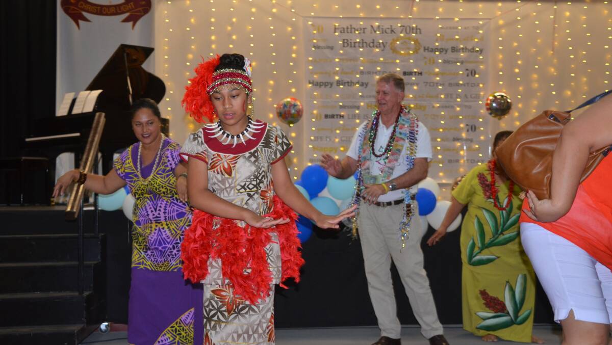 GROOVING: Father Mick joins the Pacific Island dancers on stage. Photos: Derek Barry