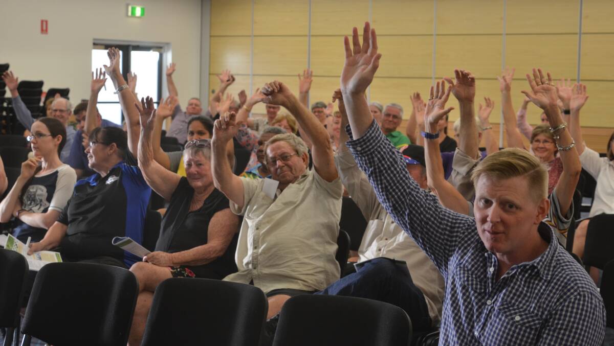 A show of hands in support of one of the Mayor's motions at the meeting.