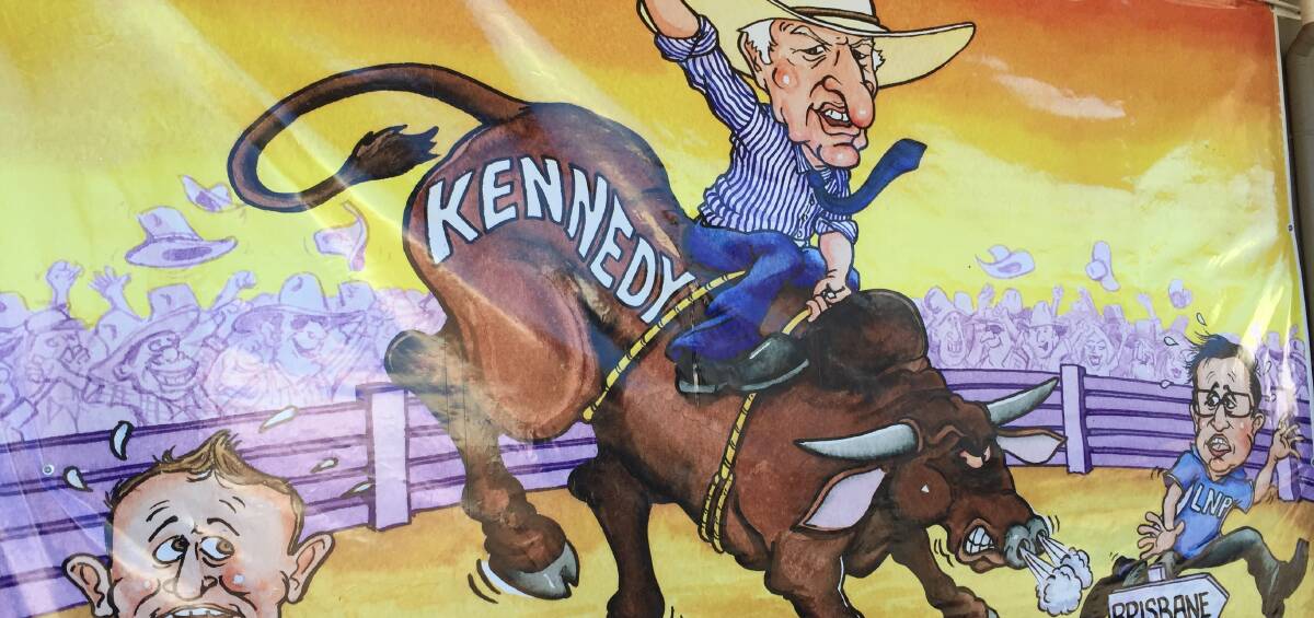 RIDE 'EM COWBOY: This large Bret Currie cartoon drapes the front window of Bob Katter's electoral office in Mount Isa.