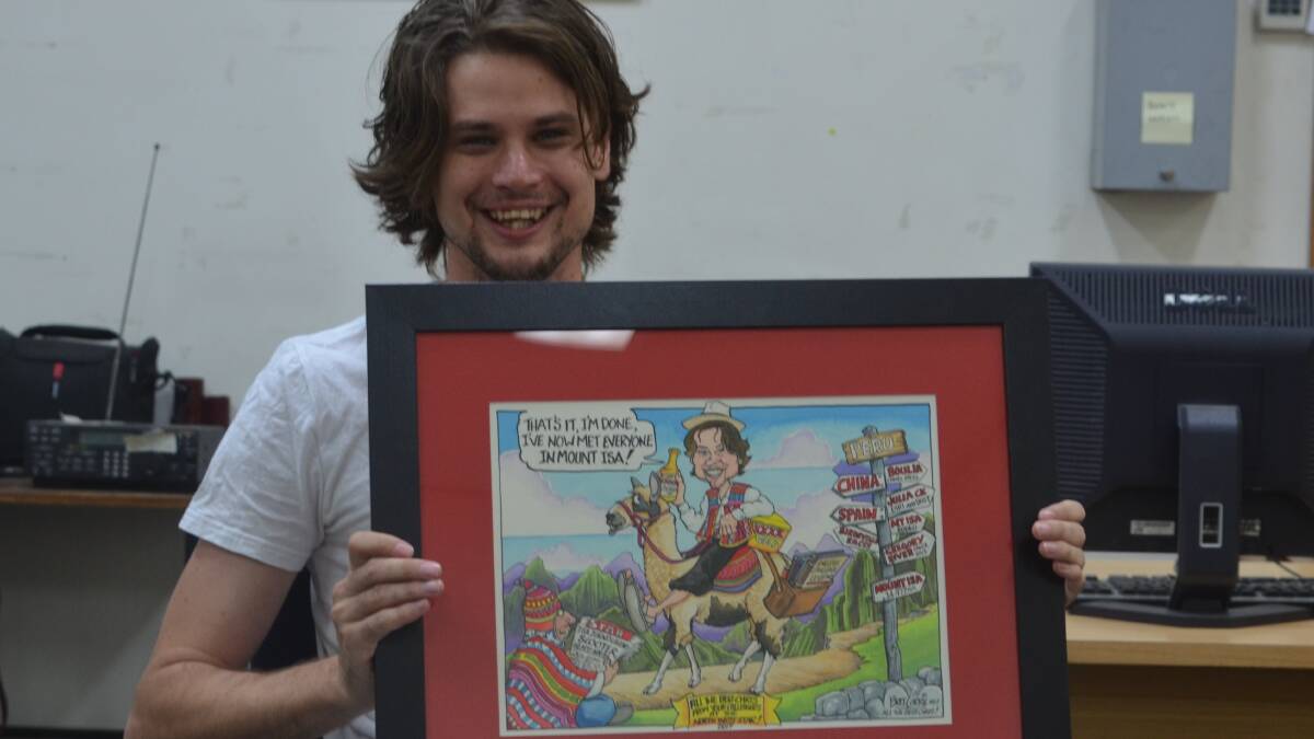 PERU BOUND: Chris Burns with his parting gift from his colleagues at the Star, a specially designed cartoon by Bret Currie. Photo: Derek Barry
