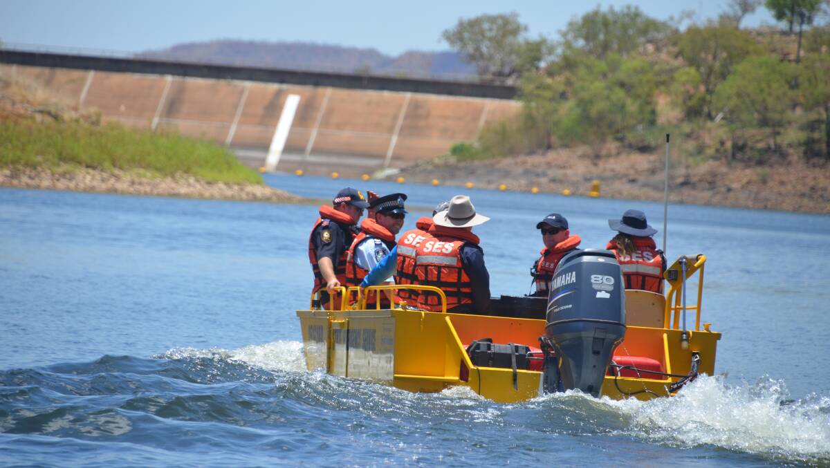 MYSTERY FISH: SES, Police, MIWB and Fish Stocking group reps head out into Lake Moondarra to release the tagged barra. The elusive $50,000 fish remained unclaimed.