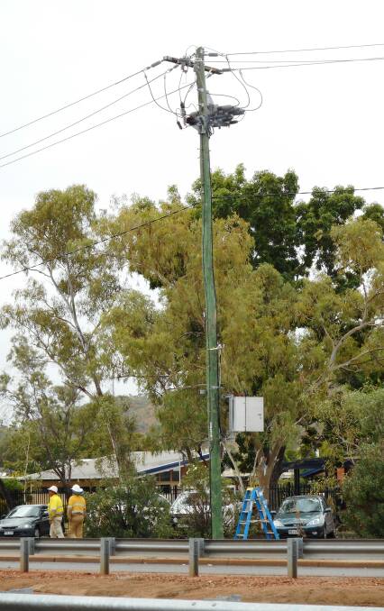 BLOW OUT: Ergon workers attend the scene on Abel Smith Parade shortly after the transformer on this pole blew out. Photos: Kevin Mabb