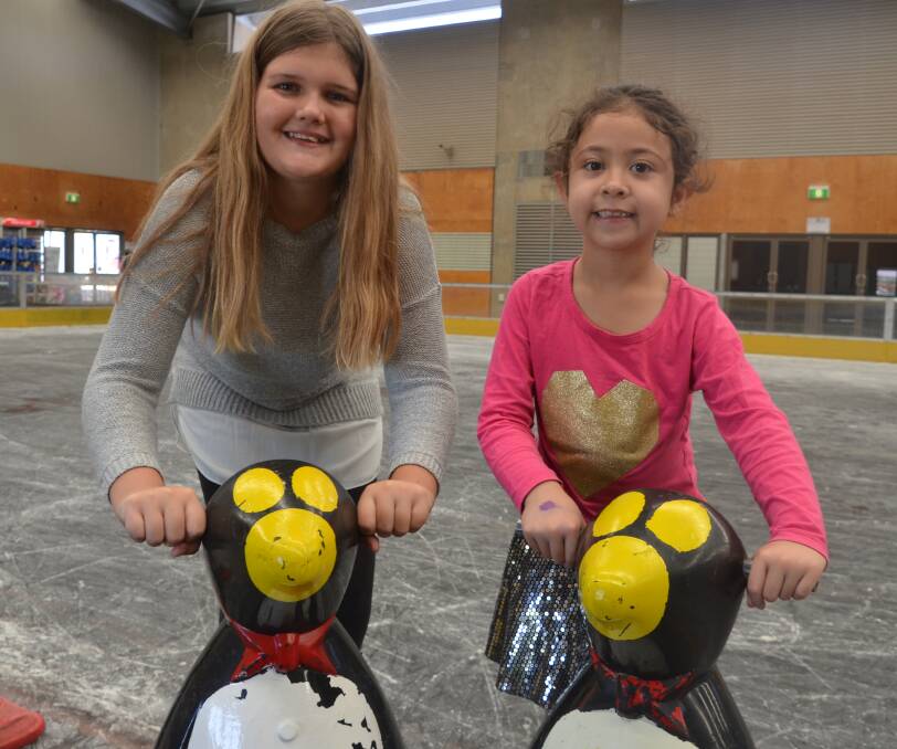 PENGUIN PARTY: Jasmin Harris and Addison Goldstein cool down at the skate rink. Photo: Derek Barry