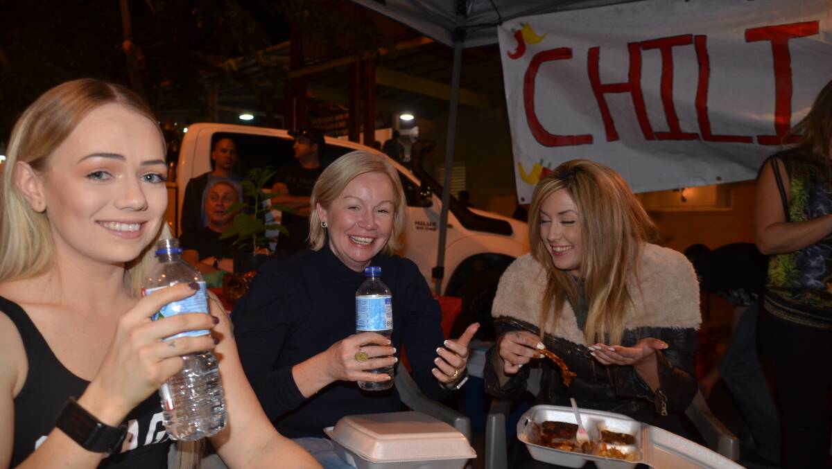 COOK OFF: Judges Kaydee Steed, Cr Peta Macrae and Antoinette Netto need water after eating their chili dishes. Photo: Derek Barry