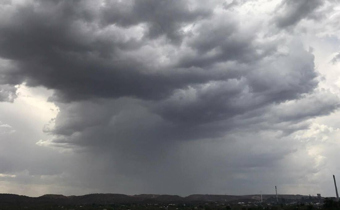 WET STUFF: Vicky Botha sent in this dramatic image of a cloud about to dump rain over Healy Heights on Friday.