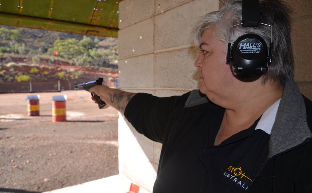 ON TARGET: Amanda Murkin takes a shot at a target at the Mount Isa Pistol Club. Photo: Derek Barry