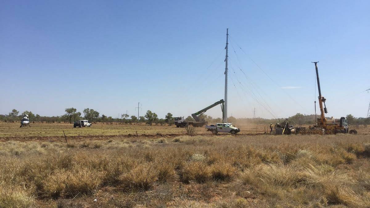 Workers install the power lines for Dugald River zinc mine last month. Photo:supplied.