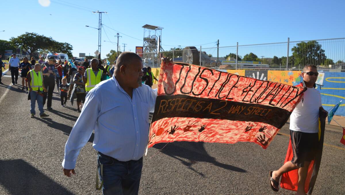 STAND PROUD: Indigenous people march for justice and equality in Mount Isa on Saturday. Photo: Derek Barry