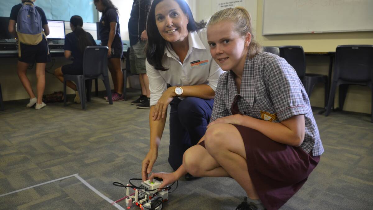 ROBOTICS: QMEA's Tammy Grady roadtests a robot with Good Shepherd student Alison Godfrey. Photo: Derek Barry