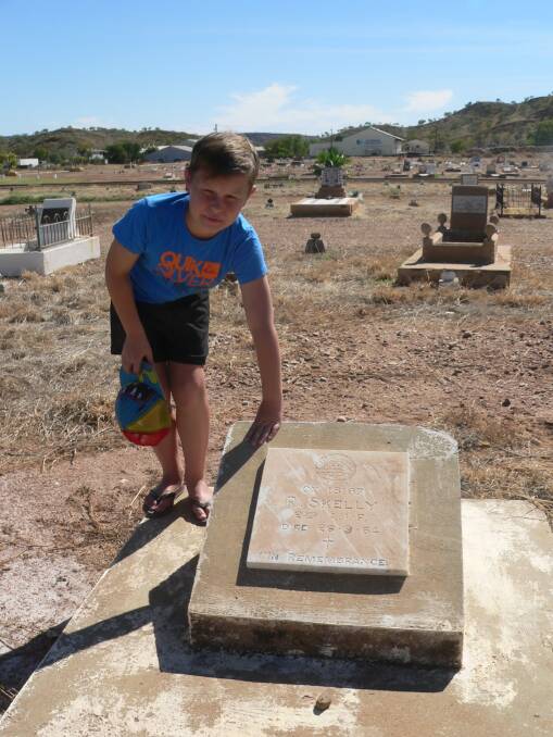 SLEUTH: Ryan Philp at the grave of Corporal Robert Skelly in Mount Isa. Photo: supplied