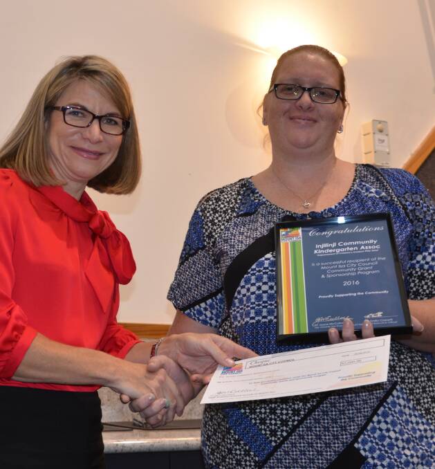 GOOD HELP: Mayor Joyce McCulloch presents the grant cheque to Rachel Horwood of the Injilinji kindy. Photo: Derek Barry