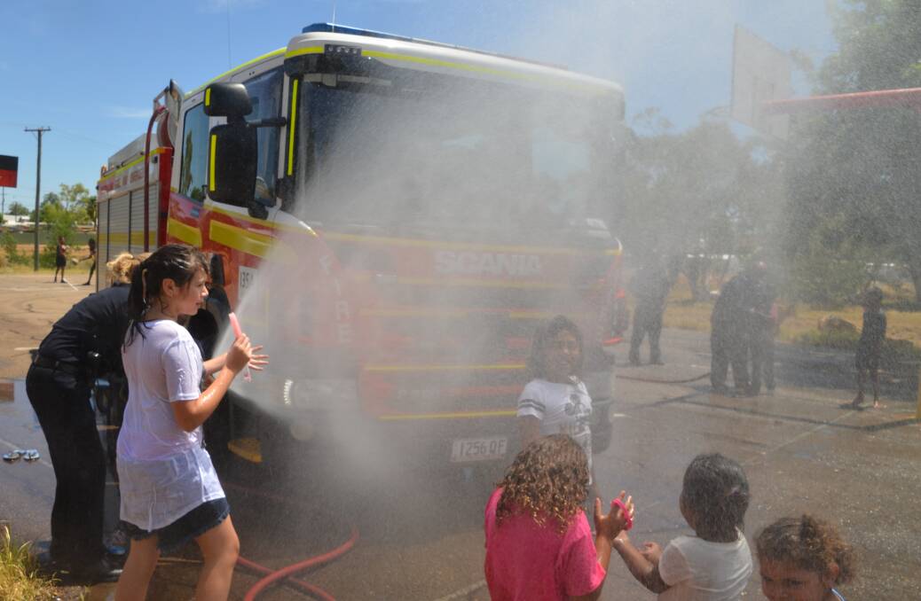 WASH DOWN: On a hot summer's day at Yallambee what better way to cool down than to use the water hose courtesy of QFES. See page 16 for more photos from the day.