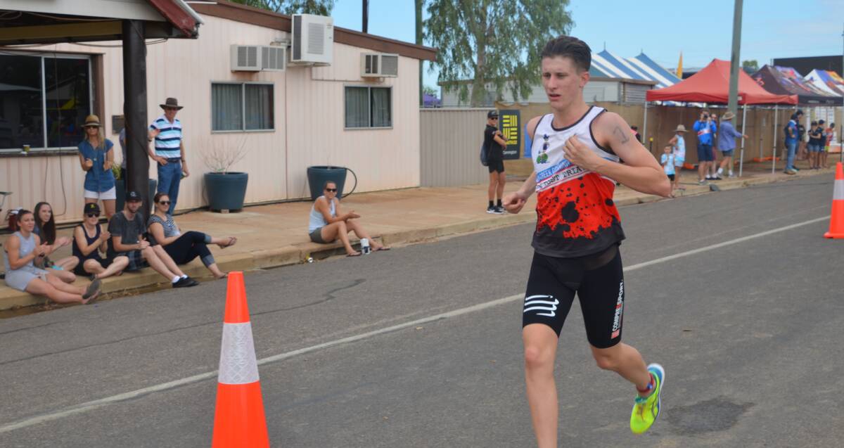 NEARLY THERE: Connor McKay is cheered on by spectators on the run leg as he wins the 2016 Julia Creek Dirt N Dust triathlon. Photo: Derek Barry