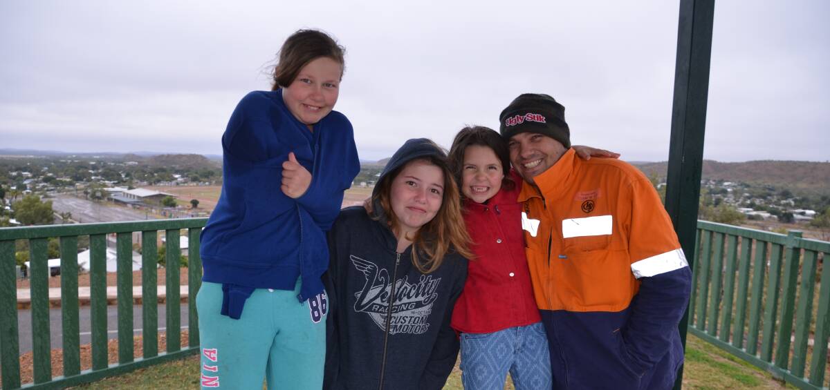 BRRR: The Tuttle family of Mount Isa braved the cold at the Lookout to watch Mum's plane disappear in the clouds: Olivia, Sophie, Chelsea and Dad Dwaine. Photo: Derek Barry