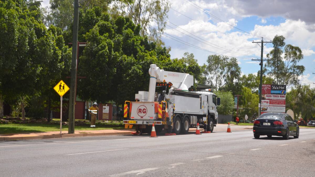 Ergon workers at the scene of the outage in Marian St.
