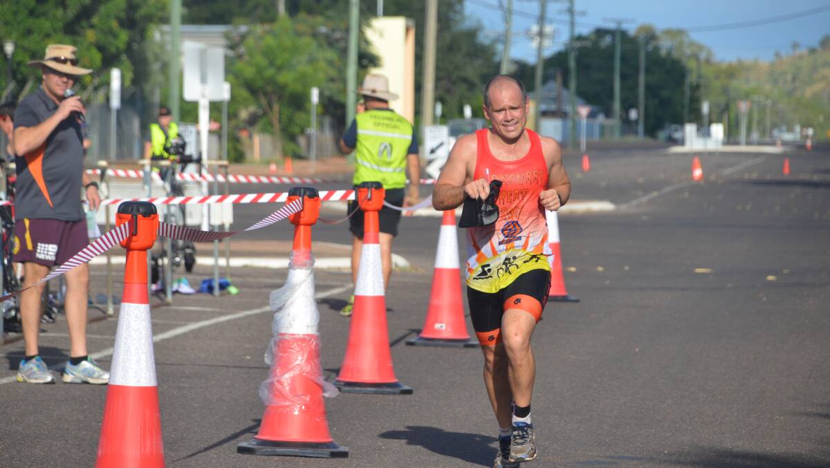 SPRINT FINISH: Kit Rix manages a smile as he powers home to win the sprint distance event at Cloncurry Heat triathlon. Photo: Derek Barry