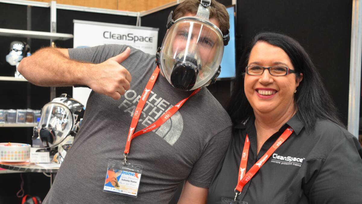 THUMBS UP: Tyrell Masterson tries out the CleanSpace respiratory protective mask at MineX with a rep of mask distributor PAFtec, Maria Fox. Photo: Derek Barry