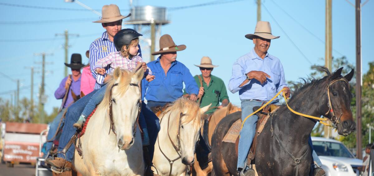 STREET PARADE: Drovers on horses lead the parade down the main street in Camooweal on Friday. Photos: Derek Barry