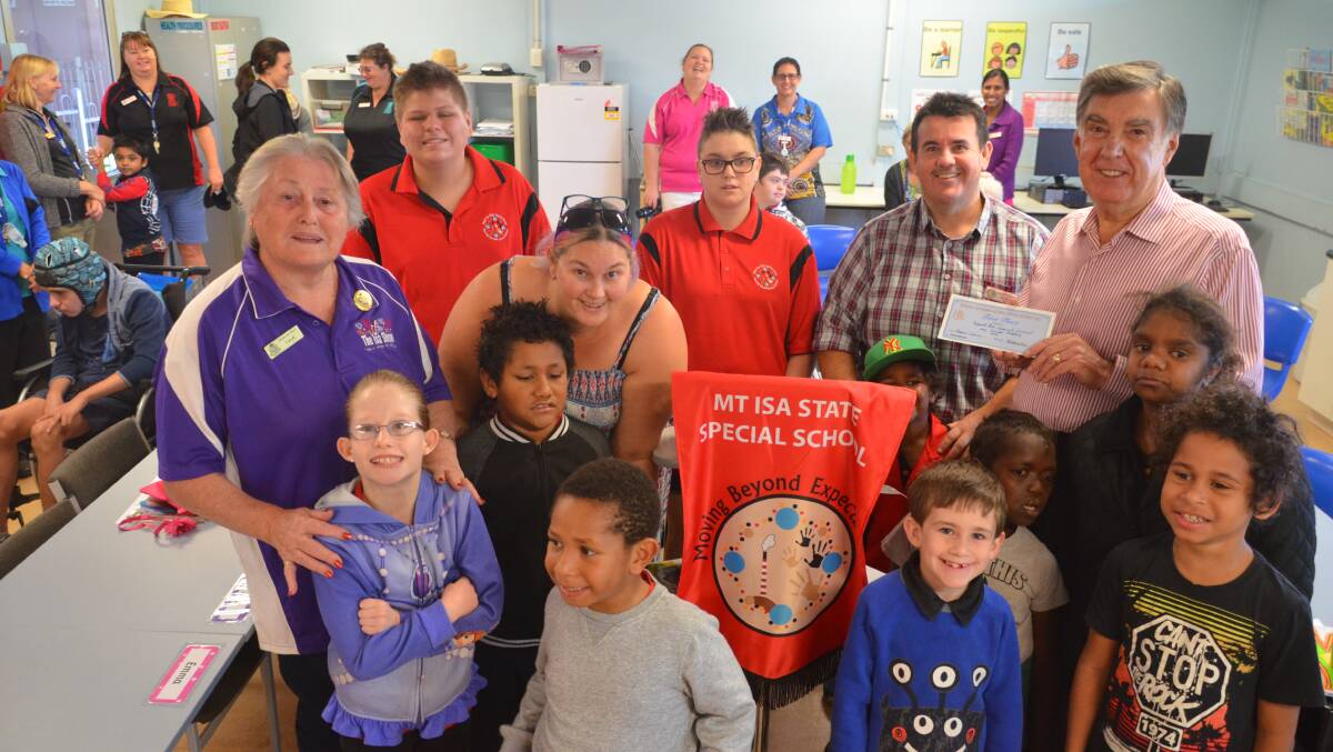 WINNERS: Special School teachers and students are delighted to get a cheque from the Mount Isa Show. Photo: Derek Barry