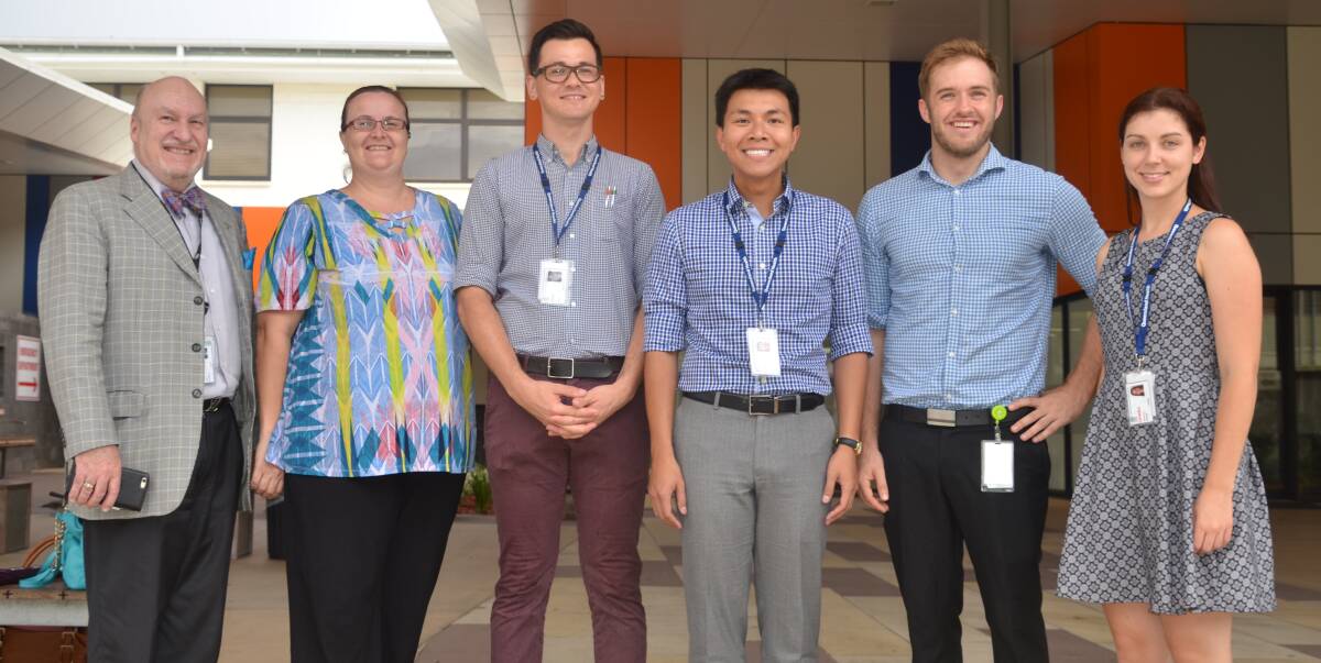 FRONT OF HOUSE: Prof Sandford with Mount Isa Hospital's new interns: Drs Patricia Murphy, Gary Sit, Duy Le, Stephen Cremonini and Gemma Williamson.