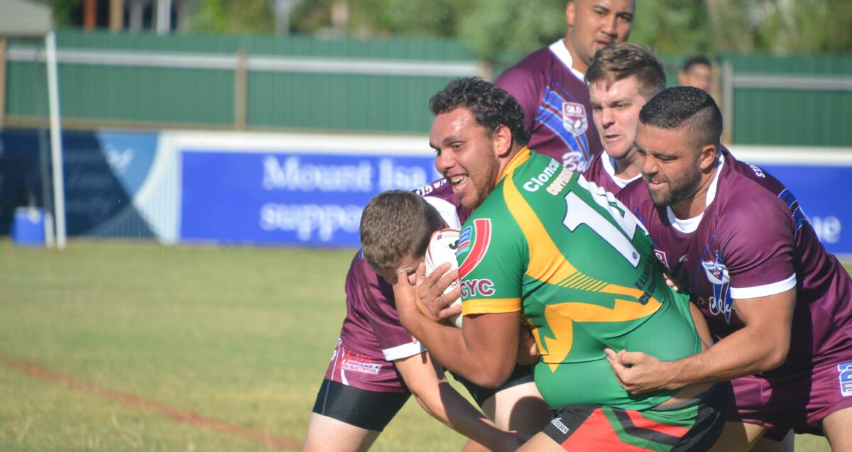 GREEN MACHINE: Cloncurry keep possession in the face of tough tackles from Townie defenders. Photo: Derek Barry