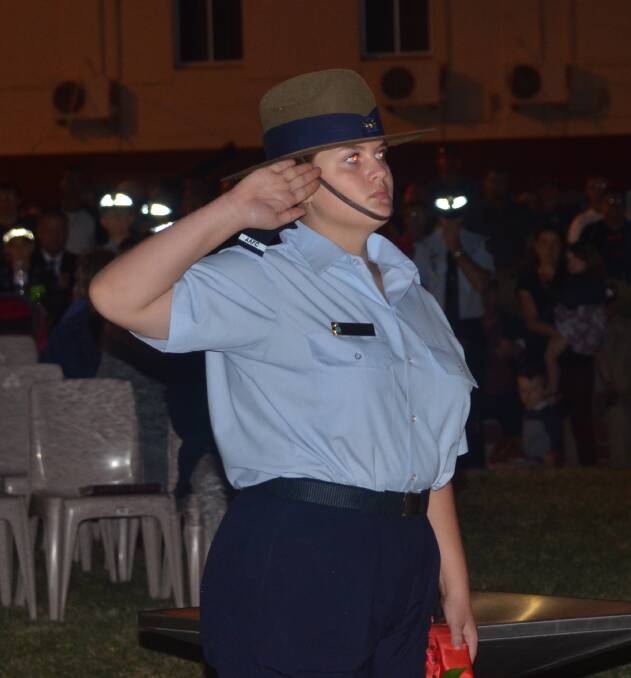 A cadet salutes the flag.