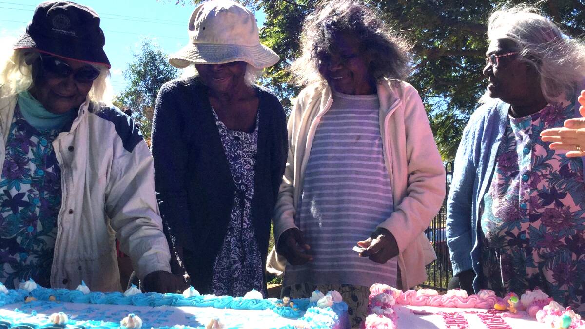 Doomadgee elders display the cakes they baked for the babies Welcome to Country day.