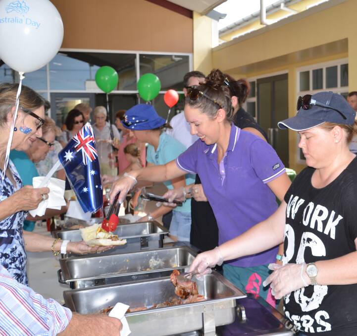 BUSH TUCKER: People enjoy a free breakfast which was served up at the 2016 Australia Day celebration in Cloncurry. Photo: Derek Barry