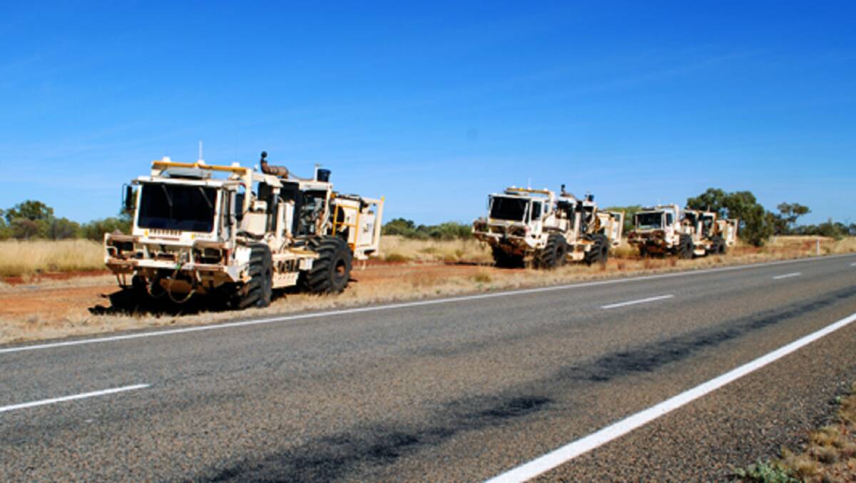 Vibroseis trucks alongside the Barkly Highway, Queensland, working on the South Nicholson Basin seismic line