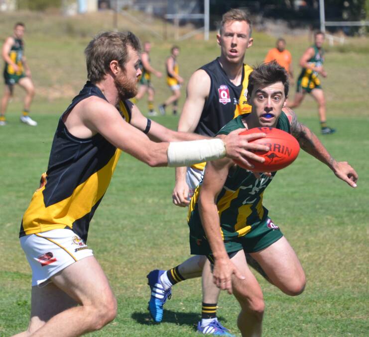 ON BALL: Tigers bring the footy away in their game against Rovers. Photo: Derek Barry