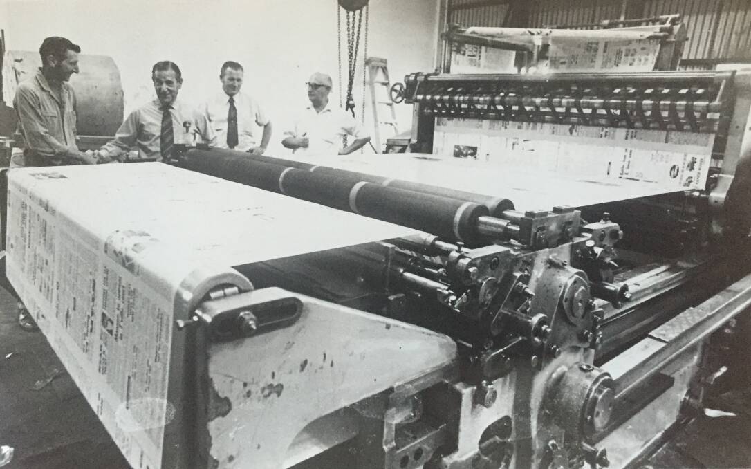 NEW BEGINNINGS: Asher Joel (second from left) looks at the new North West Star printing press.