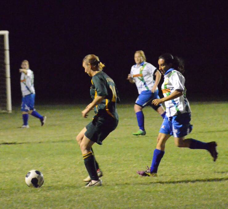 BATTLE: Isaroos left midfielder Wendy Hamilton takes on Parkside's Kerrie Dempsey during Friday night's main game. Picture: Tom Adam