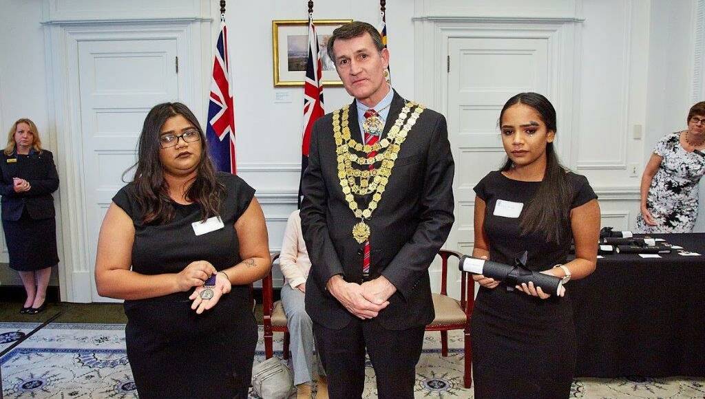BRAVE: Mary and Keely Mabb with Lord Mayor of Brisbane Cr Graham Quirk, receiving a bravery award on behalf of their mother Donna Chong.