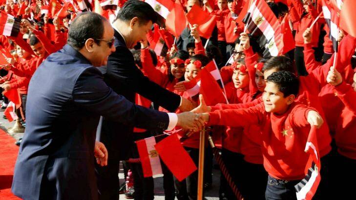 Egyptian President Abdel-Fattah el-Sissi, left, and Chinese President Xi Jinping, shake hands with children at the Presidential Palace in Cairo, Egypt on Thursday. Jinping is on a two-day visit to the country.  Photo: Handout/AP