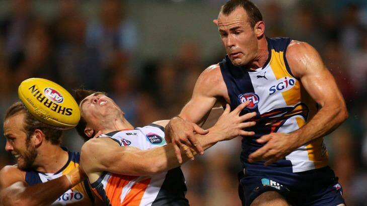 Jeremy Cameron cops a whack in a marking contest with Eagles Will Schofield and Shannon Hurn.