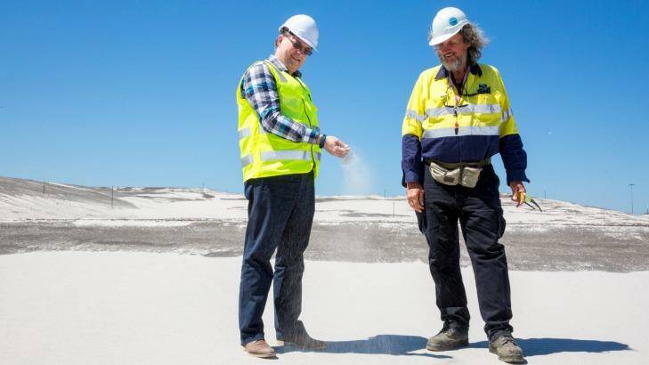 Brisbane New Parallel Runway project director Paul Coughlan (left) with works inspector Des Hasemann on top of 11 million cubic metres of sand that has "settled" almost three metres and is now ready to become Brisbane's new runway. Photo: Tammy Law