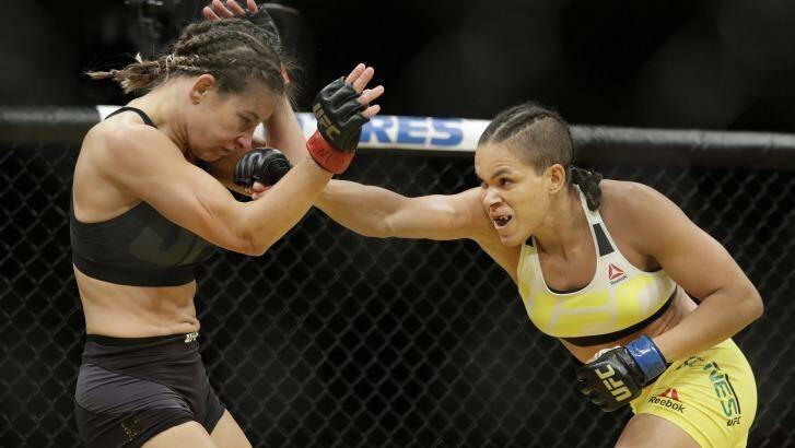 Amanda Nunes lands a punch on Miesha Tate on her way to the women's bantamweight belt at UFC 200. Photo: John Locher